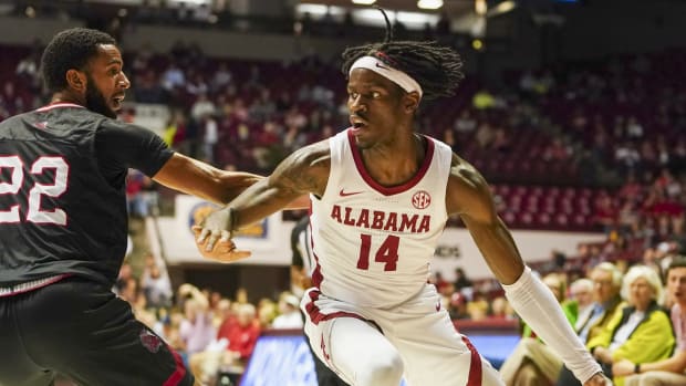 Dec 18, 2021; Tuscaloosa, Alabama, USA; Alabama Crimson Tide guard Keon Ellis (14) drives to the basket against Jacksonville State Gamecocks guard Jalen Gibbs (22) during the first half at Coleman Coliseum. Mandatory Credit: Marvin Gentry-USA TODAY Sports